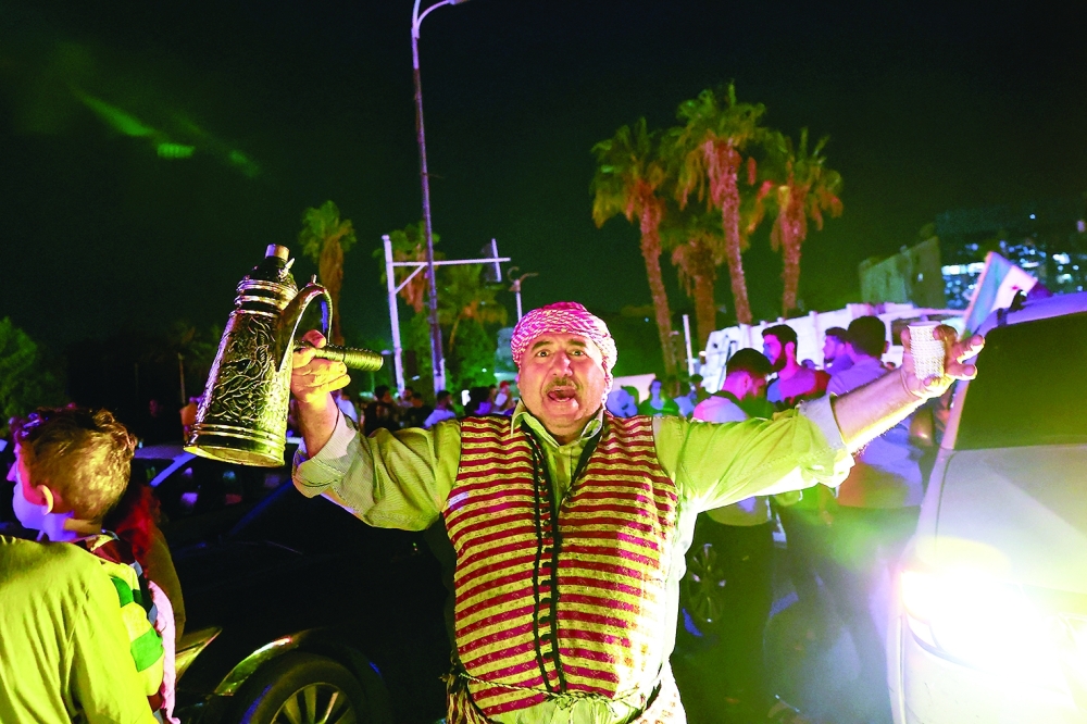 People celebrate after U.S. President Donald Trump said on Tuesday he would order the lifting of sanctions on Syria