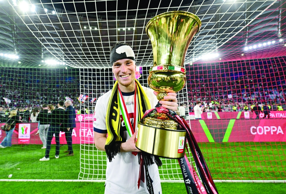 Bologna's Sam Beukema celebrates with the trophy after winning the Coppa Italia. — Reuters