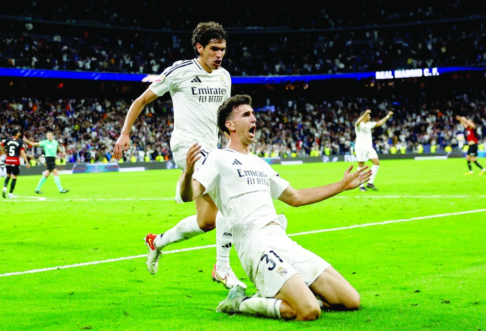 Real Madrid's Jacobo Ramon celebrates scoring their second goal with Real Madrid's Jesus Vallejo. — Reuters