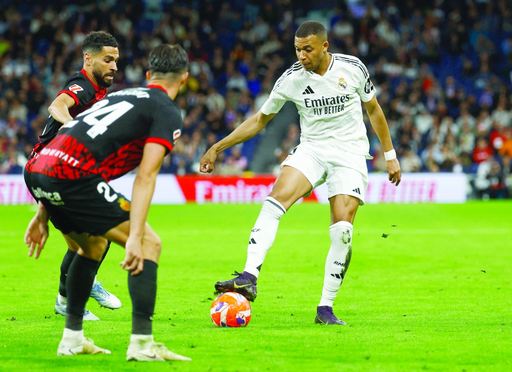 Real Madrid's Kylian Mbappe in action with RCD Mallorca's Martin Valjent. — Reuters