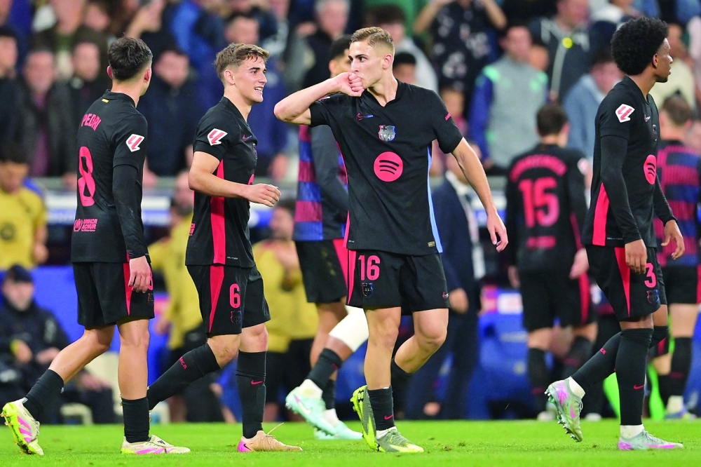 Barcelona's Spanish midfielder #16 Fermin Lopez celebrates scoring his team's second goal during the Spanish league football match between RCD Espanyol and FC Barcelona at the RCDE Stadium in Cornella de Llobregat, on May 15, 2025. (Photo by MANAURE QUINTERO / AFP)

