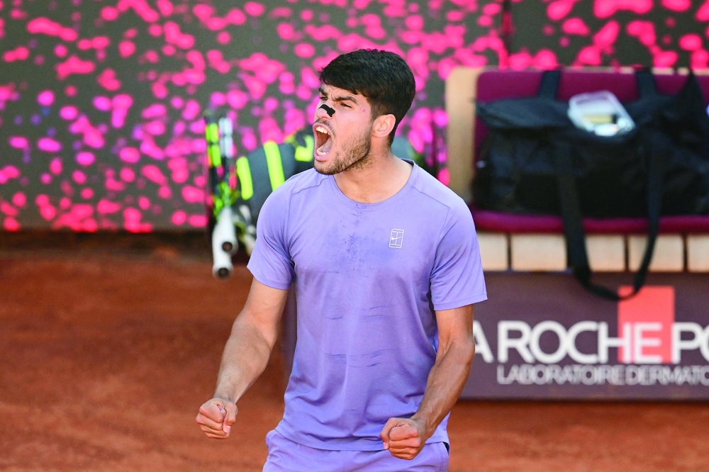 Spain's Carlos Alcaraz celebrates his victory during his men's singles semi-final match against Italy's Lorenzo Musetti for the ATP Rome Open tennis tournament at Foro Italico in Rome on May 16, 2025.  (Photo by Tiziana FABI / AFP)

