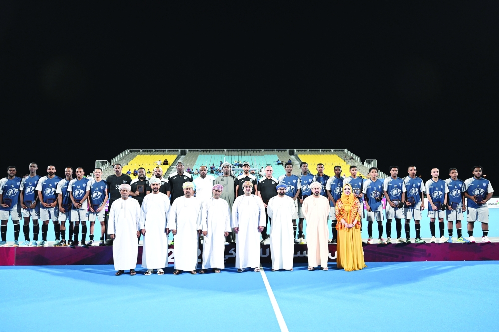 Salalah players pose with their runners-up medals.