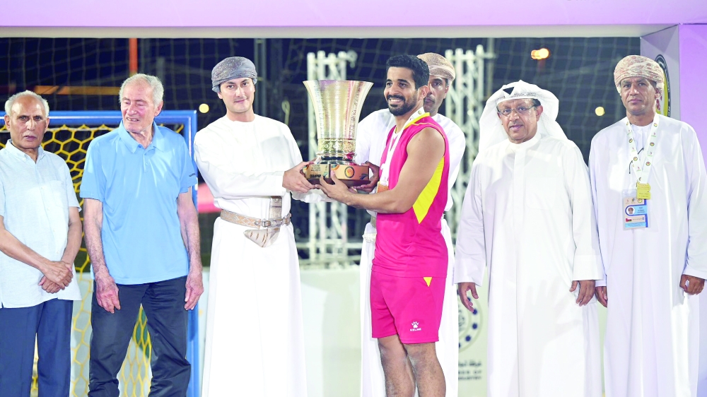 Oman captain Said al Hasani receives the trophy.