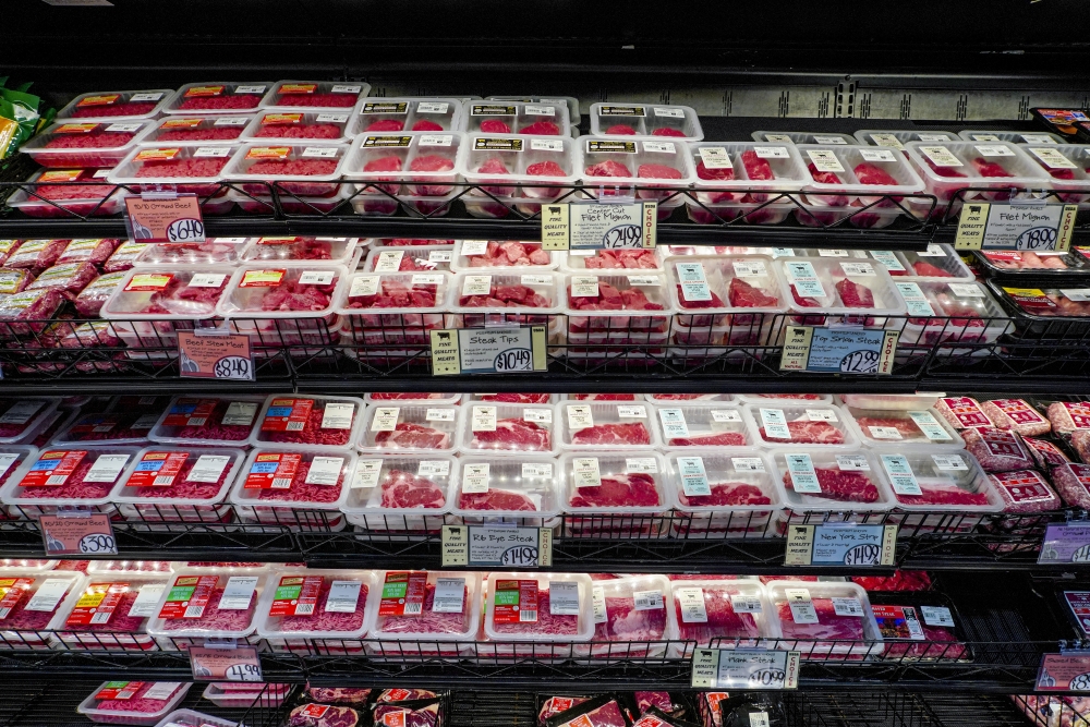 Beef packaged in plastic is displayed for sale at a supermarket