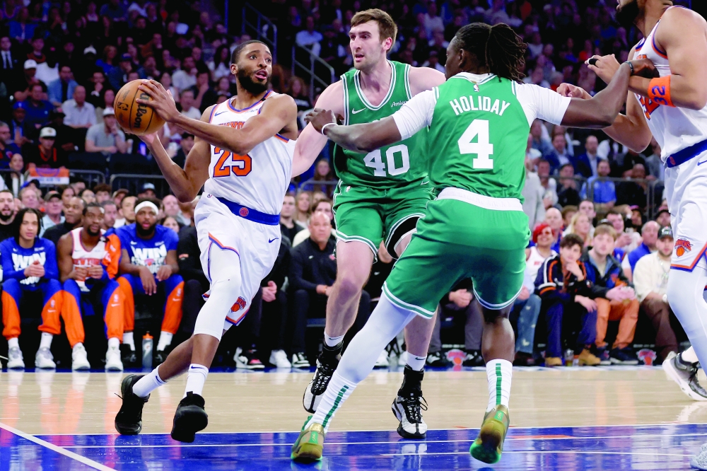 New York Knicks forward Mikal Bridges (25) drives to the basket against Boston Celtics center Luke Kornet (40) and guard Jrue Holiday (4) during the first quarter of game six in the second round of the 2025 NBA Playoffs at Madison Square Garden. — Reuters