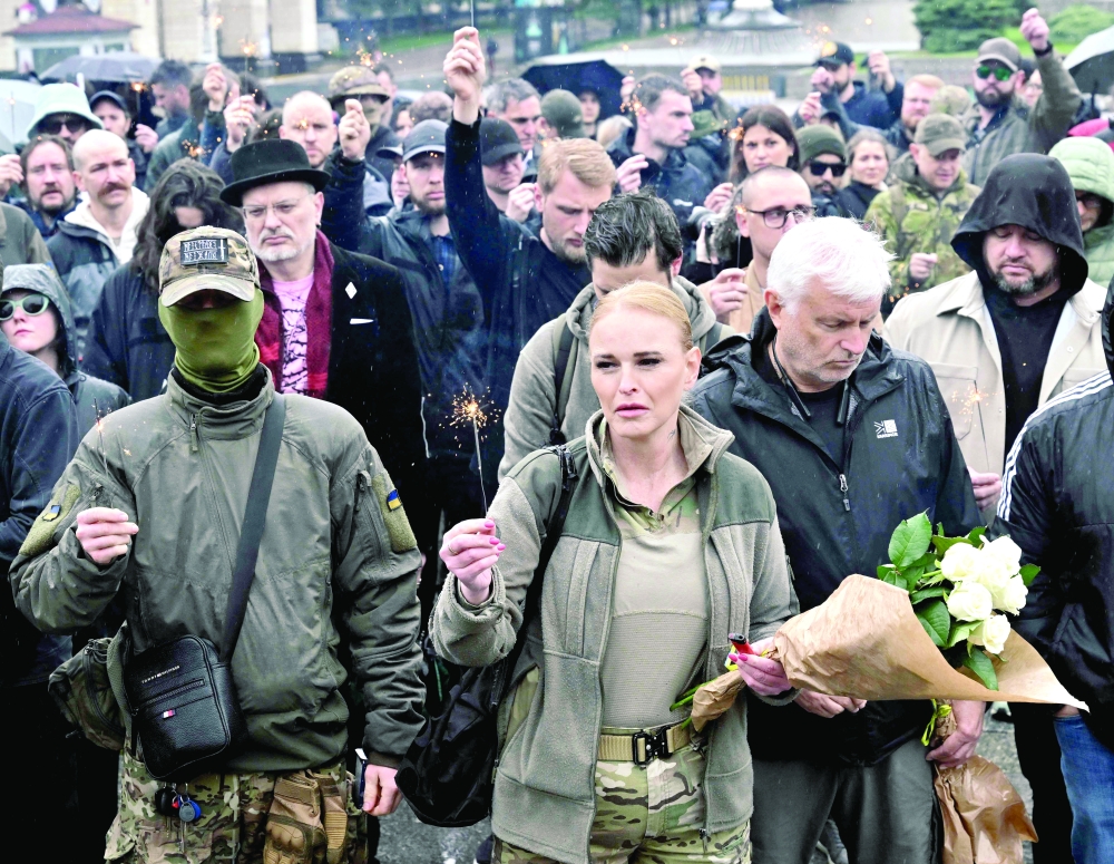 People take part in a public honouring memorial, at Independence Square in Kyiv. — AFP