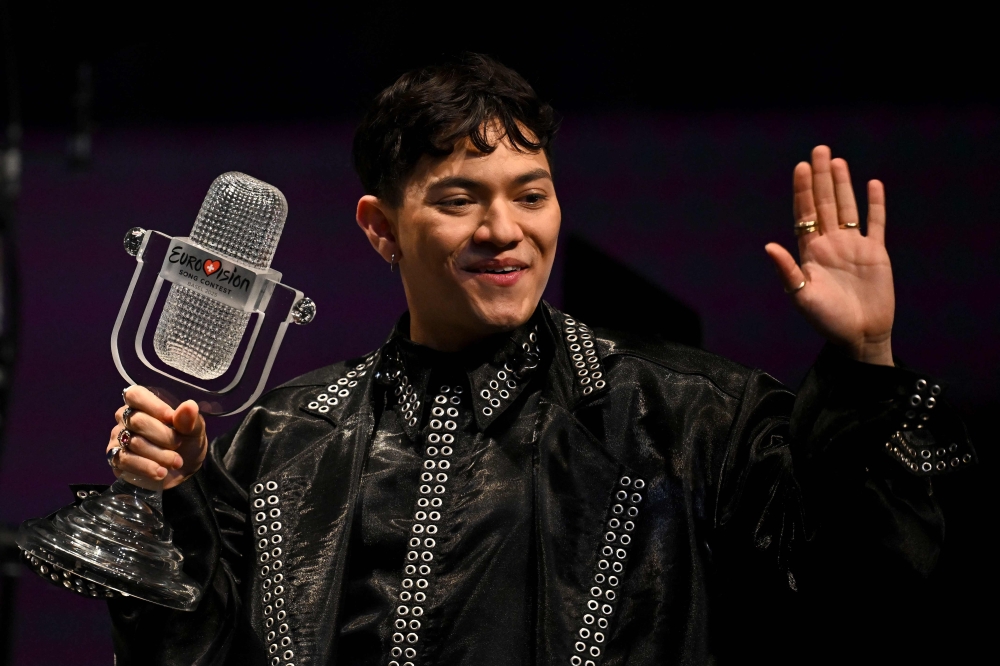 Austrian singer Johannes Pietsch, known as JJ representing Austria with the song "Wasted Love" celebrates with the 2025 Eurovision Song Contest trophy after winning the grand final at the St. Jakobshalle arena in Basel on May 18, 2025. (Photo by Fabrice COFFRINI / AFP)
