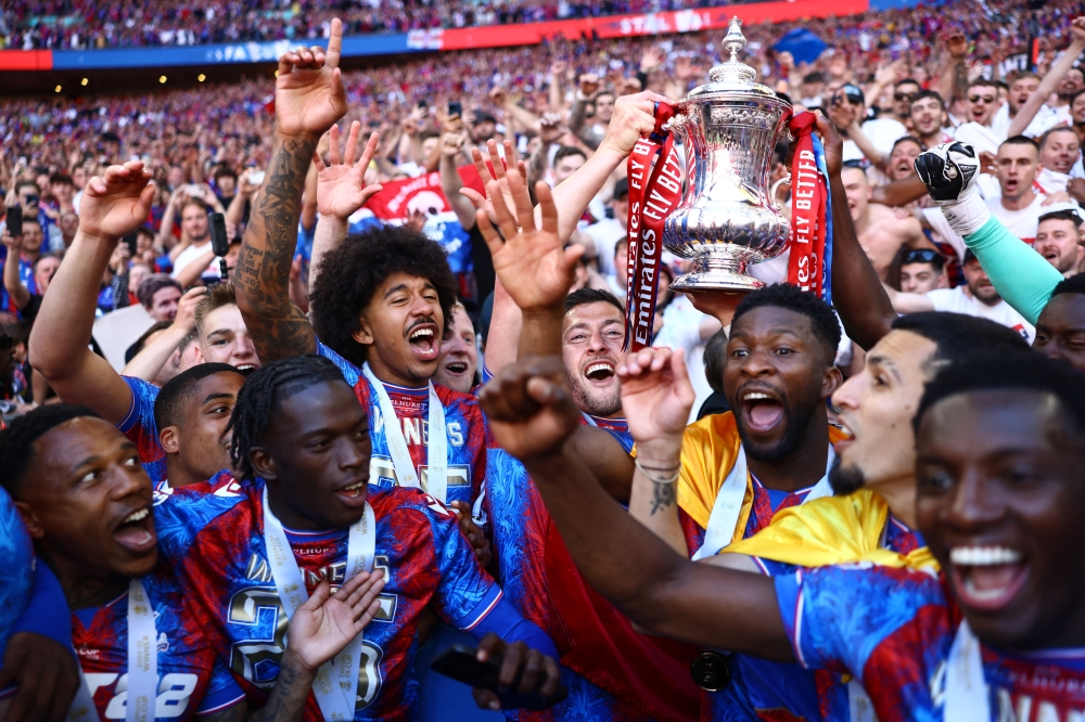 Crystal Palace's Joel Ward celebrates with teammates and the trophy after winning the FA Cup. — Reuters