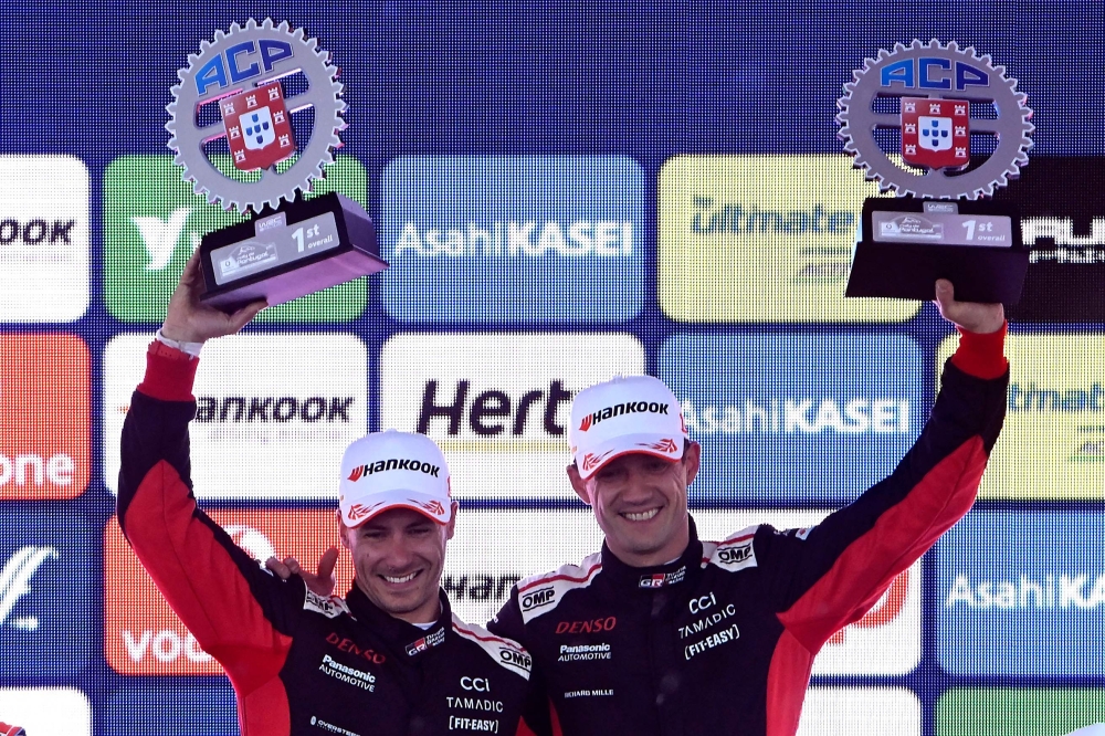 French driver Sebastien Ogier (R) and co-driver Vincent Landais celebrate on the podium winning the World Rally Championship (WRC) Rally of Portugal, at the end of the SS24 stage in Fafe. — AFP
