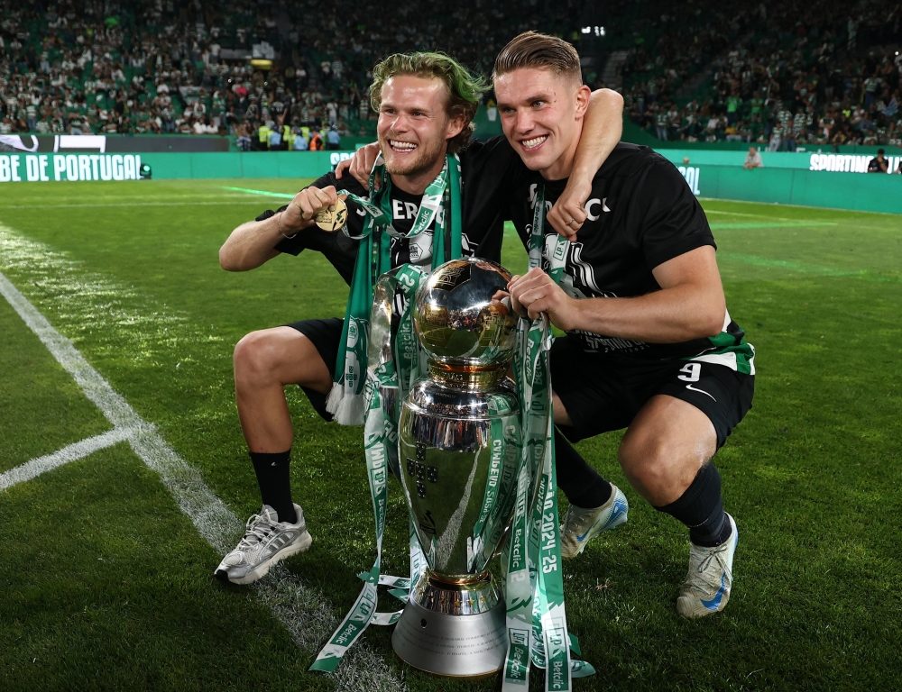 Sporting CP's Viktor Gyokeres and Morten Hjulmand celebrate with the trophy after winning the Primeira Liga. — Reuters