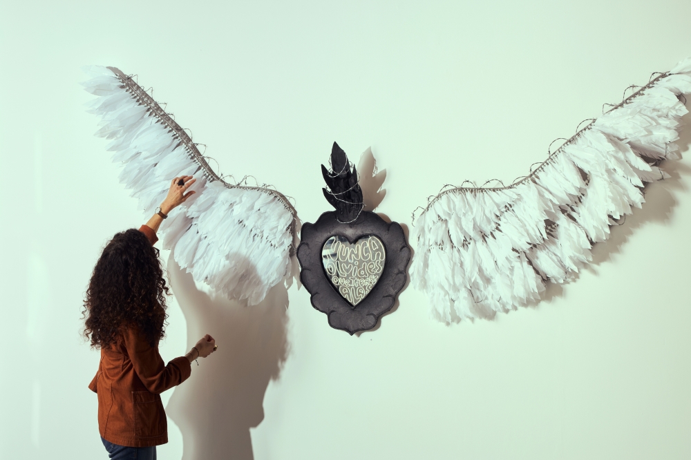 Patricia Espinosa adjusts her installation “Nunca olvides que tienes alas” (translation: never forget you have wings) at the BronxArtSpace in New York, May 6, 2025. (Luis Corzo/The New York Times)