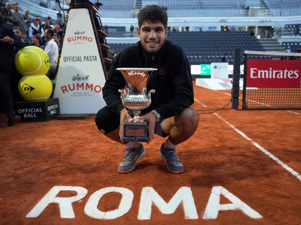 Spain's Carlos Alcaraz poses for a photo with the trophy after winning the final against Italy's Jannik Sinner. — Reuters
