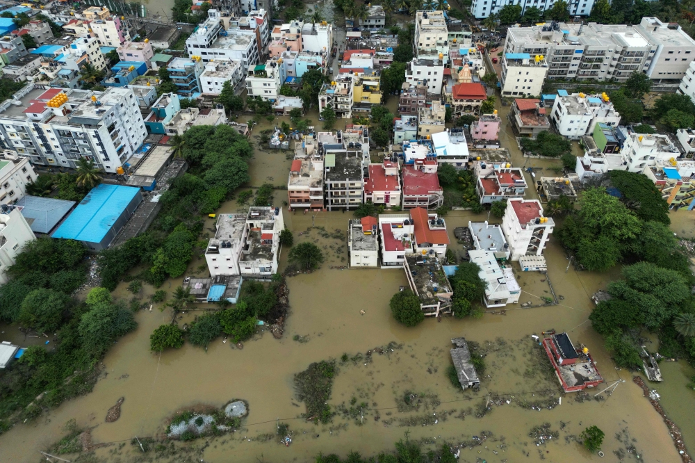 TOPSHOT - An aerial view shows a flooded locality following heavy rainfall in Bengaluru on May 19, 2025. (Photo by Idrees MOHAMMED / AFP)
