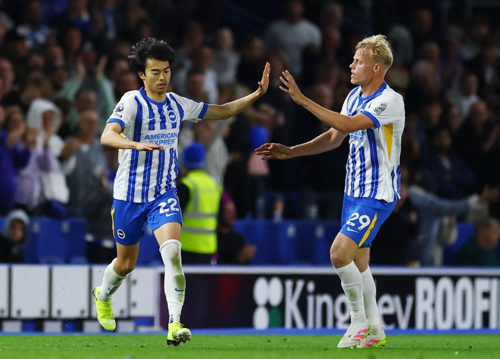 Brighton & Hove Albion's Kaoru Mitoma celebrates scoring their second goal with Jan Paul van Hecke. — Reuters
