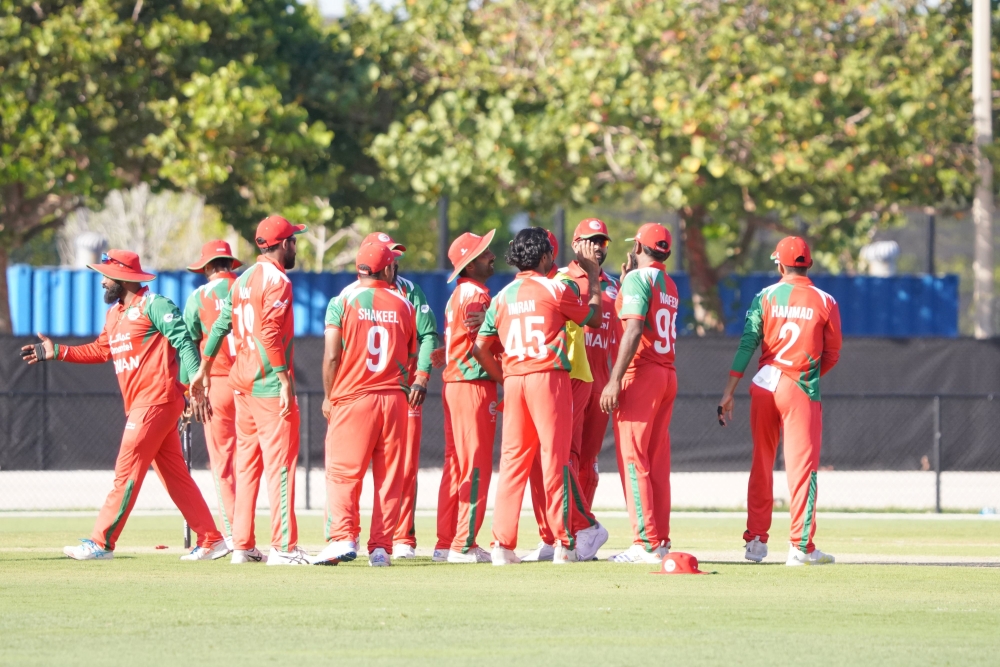 Oman celebrating a wicket.
