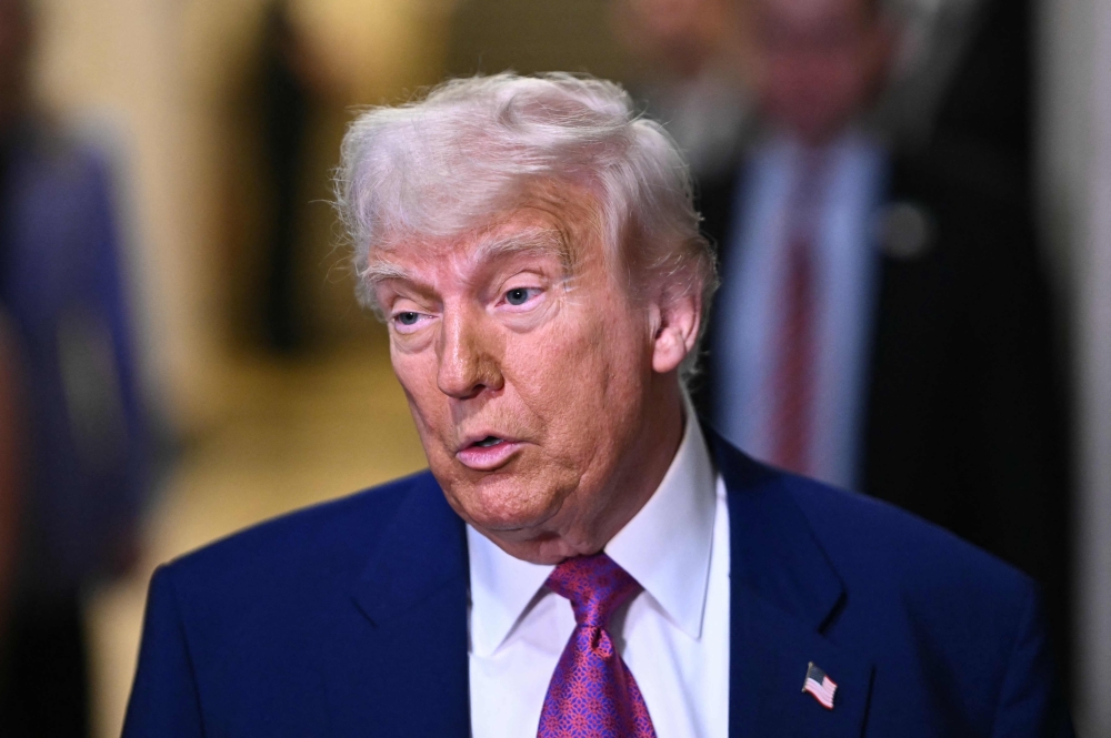 US President Donald Trump speaks to reporters as he arrives for a House Republican meeting at the US Capitol in Washington, DC, on Tuesday. - AFP