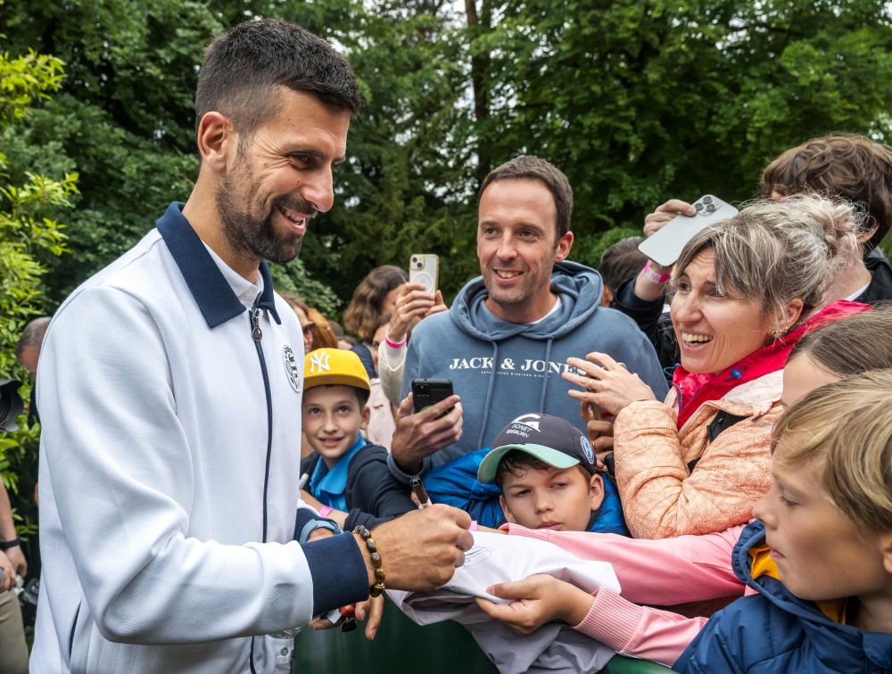 Serbia's Novak Djokovic signs autograph after a press conference ahead of his match at the ATP 250 Geneva Open tennis tournament in Geneva on May 20, 2025. (Photo by FABRICE COFFRINI / AFP)

