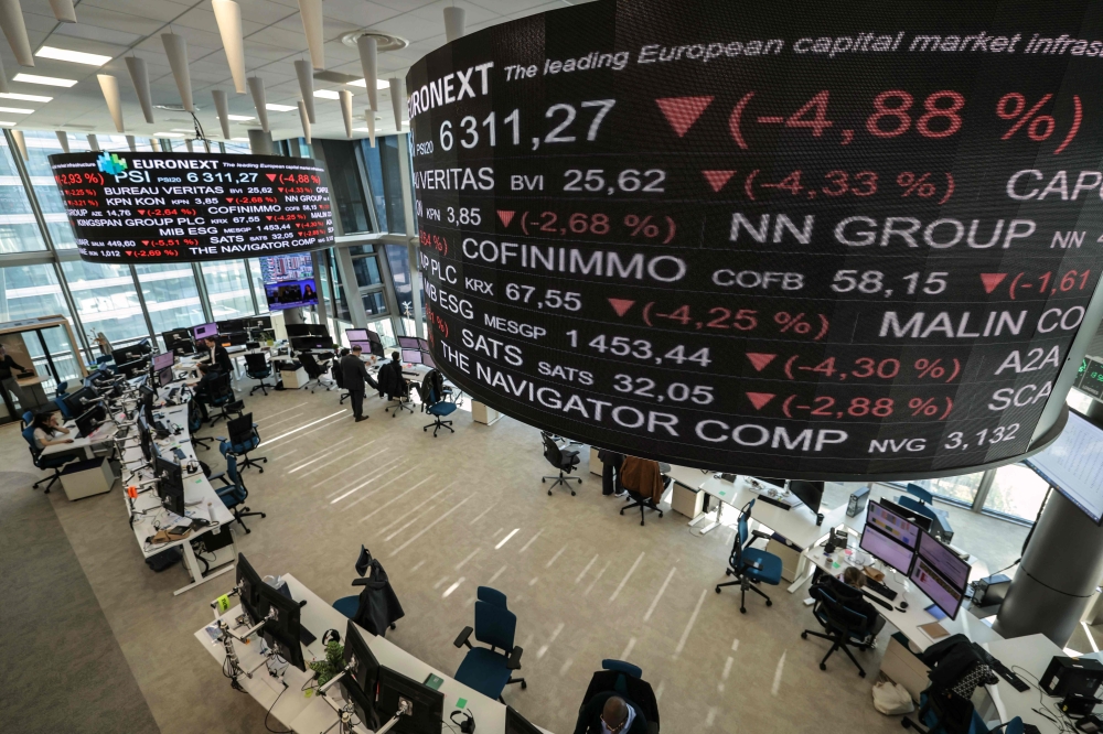 Market indicators are displayed on digital screen at the Euronext trading exchange building in La Defense business district, west of Paris. - AFP