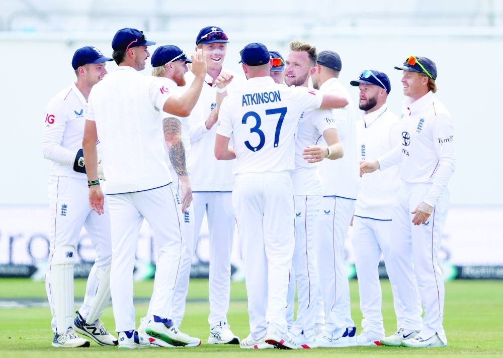 England's Sam Cook celebrates with teammates. — Reuters