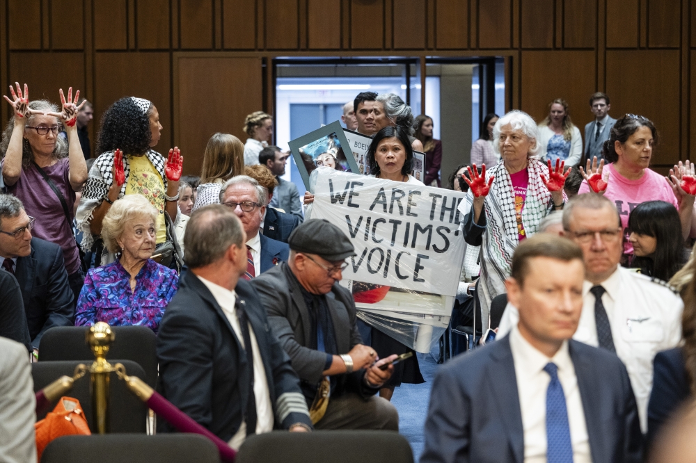 Demonstrators at a Homeland Security and Governmental Affairs Subcommittee on Investigations hearing at the Hart Senate Office Building in Washington, on Tuesday, June 18, 2024. (Eric Lee/The New York Times)