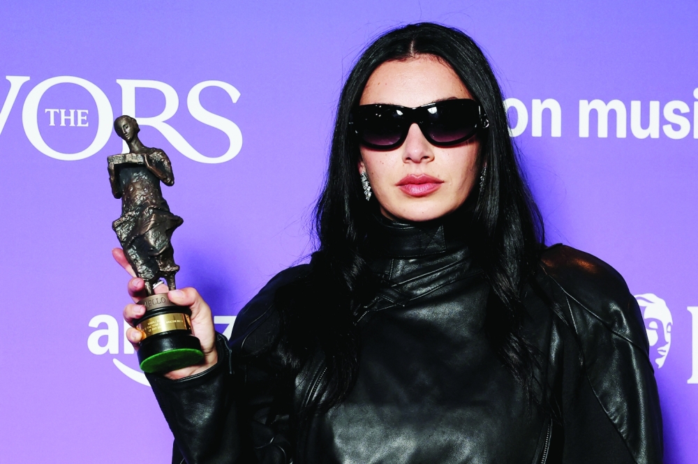 Charli XCX poses for a portrait holding her Songwriter of the Year with Amazon Music award at the Ivor Novello Awards in London, Britain, May 22, 2025. REUTERS/Toby Melville
