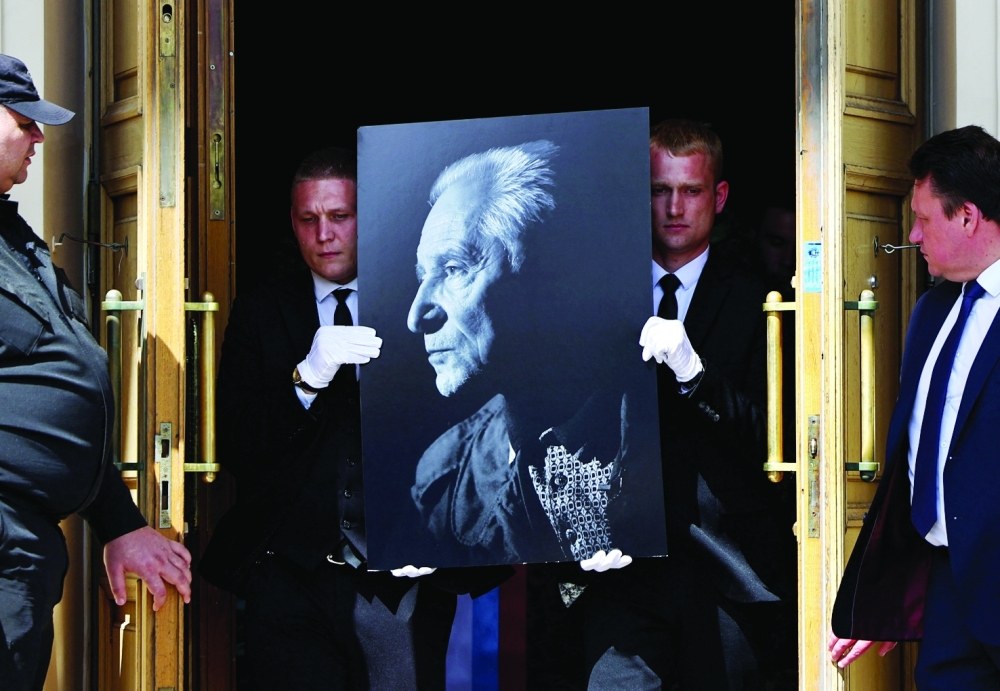 Participants of a memorial ceremony carry a portrait of Russian ballet choreographer Yuri Grigorovich, who died at the age of 98, at the Bolshoi Theatre in Moscow, Russia, May 23, 2025. REUTERS/Evgenia Novozhenina