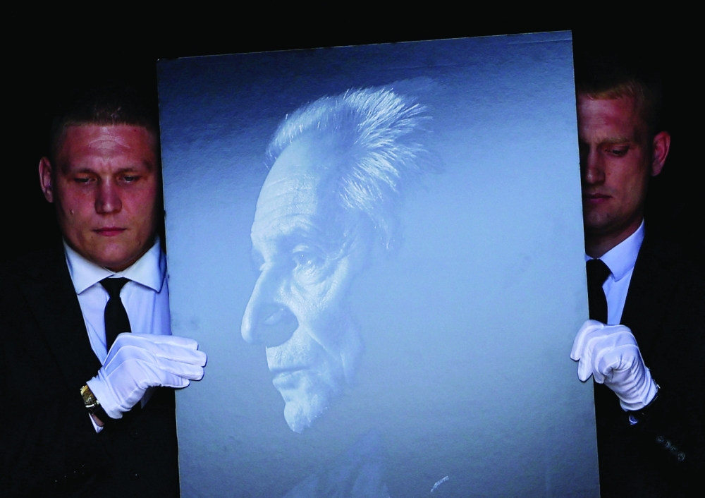 Participants of a memorial ceremony carry a portrait of Russian ballet choreographer Yuri Grigorovich, who died at the age of 98, at the Bolshoi Theatre in Moscow, Russia, May 23, 2025. REUTERS/Evgenia Novozhenina
