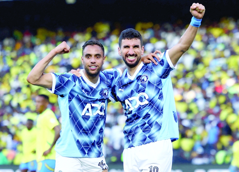 Pyramids' Walid el Karti celebrates scoring their first goal with Mohamed Chibi. — Reuters