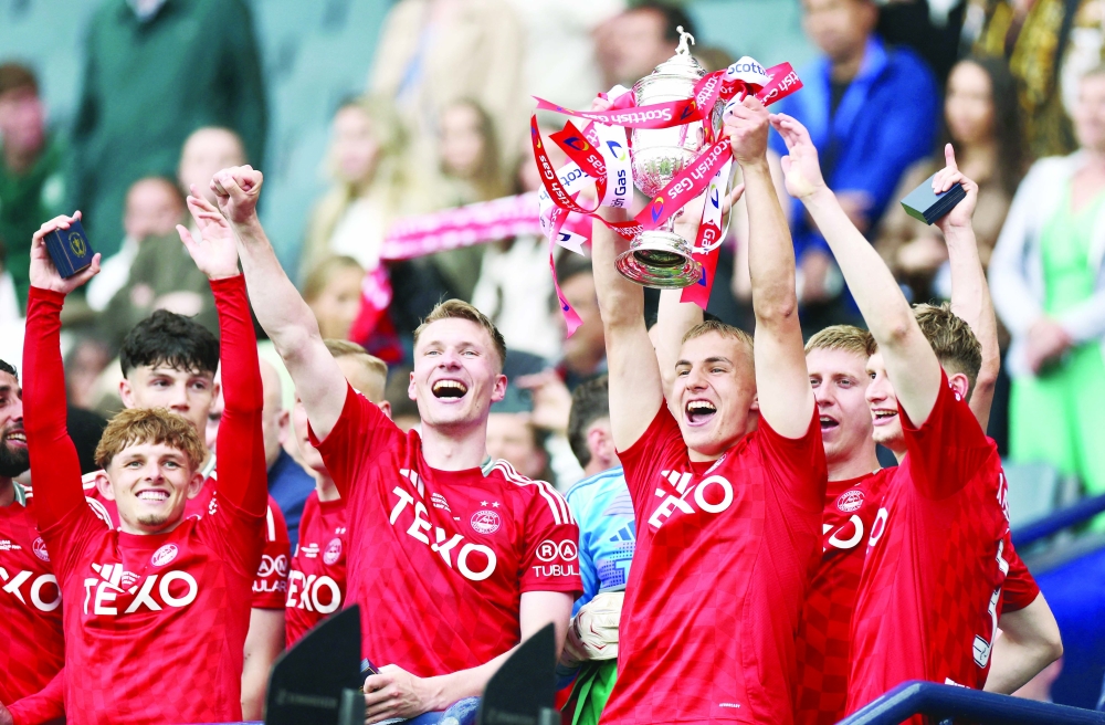 Aberdeen's Topi Keskinen lifts the trophy with teammates after winning the Scottish Cup Final. — Reuters