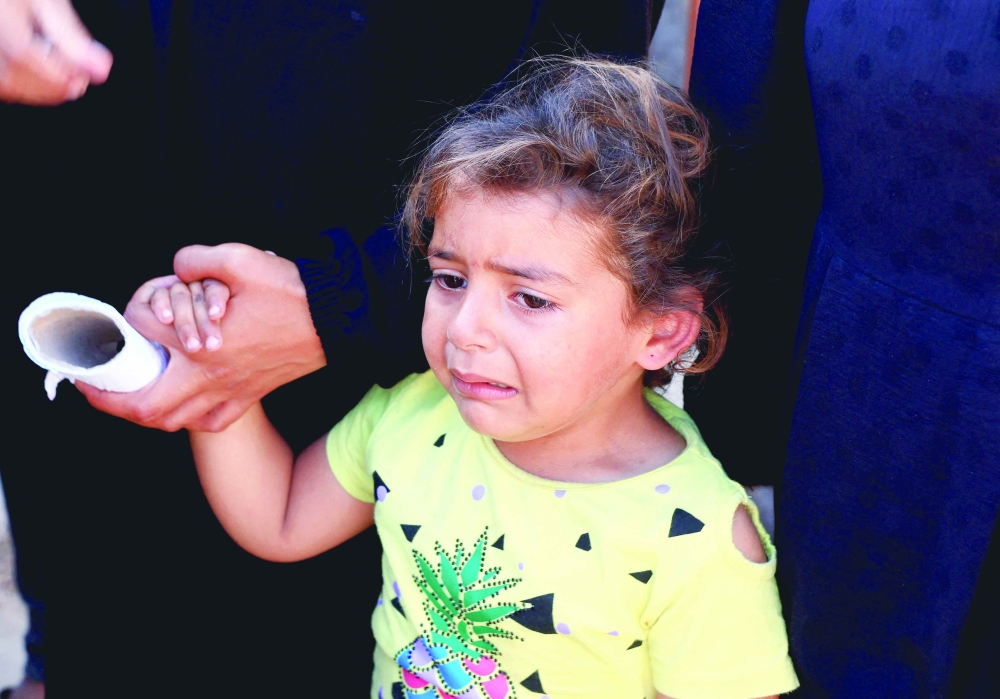 A girl reacts during the funeral of Palestinians killed in Israeli strikes, at Nasser hospital, in Khan Yunis, southern Gaza Strip, on Sunday. — Reuters