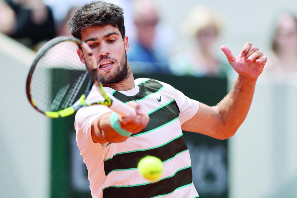 Spain's Carlos Alcaraz in action during his first round match against Italy's Giulio Zeppieri. — Reuters