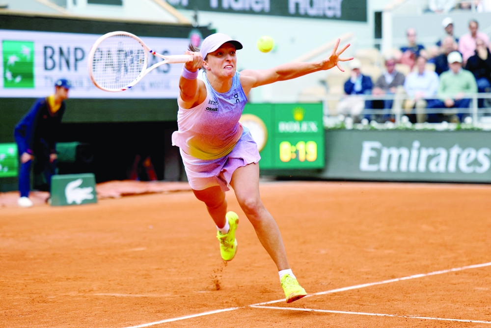Poland's Iga Swiatek in action during her first round match against Slovakia's Rebecca Sramkova. — Reuters