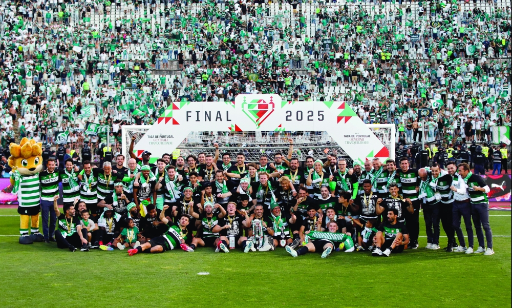 Sporting CP players and staff celebrates with the trophy after winning the Taca de Portugal. — Reuters