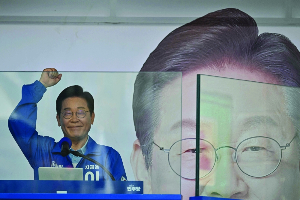 Lee Jae-myung, the presidential candidate of the Democratic Party, gestures during an election campaign event in Suwon, on Monday. — AFP