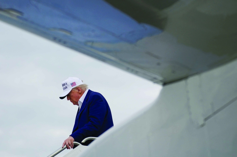 US President Donald Trump disembarks Air Force One as he arrives at Joint Base Andrews, Maryland, US, on Monday. — Reuters