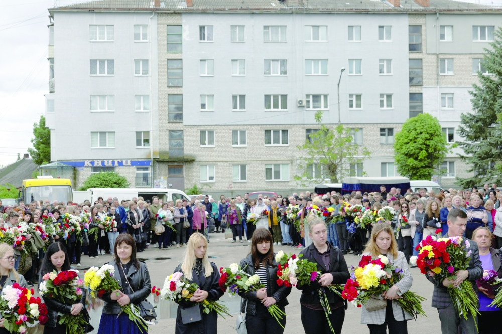 Locals pay their last respects to children who were killed in Korostyshiv, Zhytomyr region, Ukraine. — Reuters