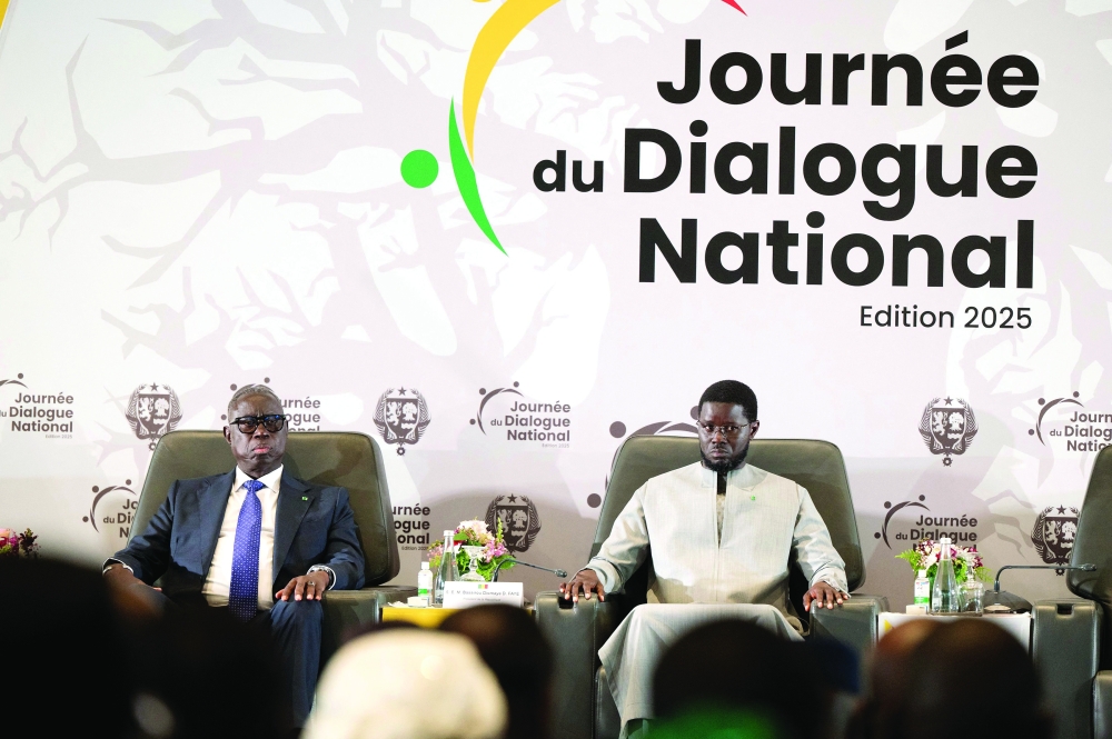 Senegal's President Bassirou Diomaye Faye (R) and Senegal's Interior Minister Jean Baptiste Tine (L) attend the opening, in Diamniadio. — AFP