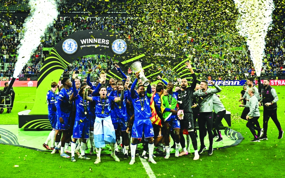 Reece James lifts the trophy as he celebrates with teammates. — Reuters