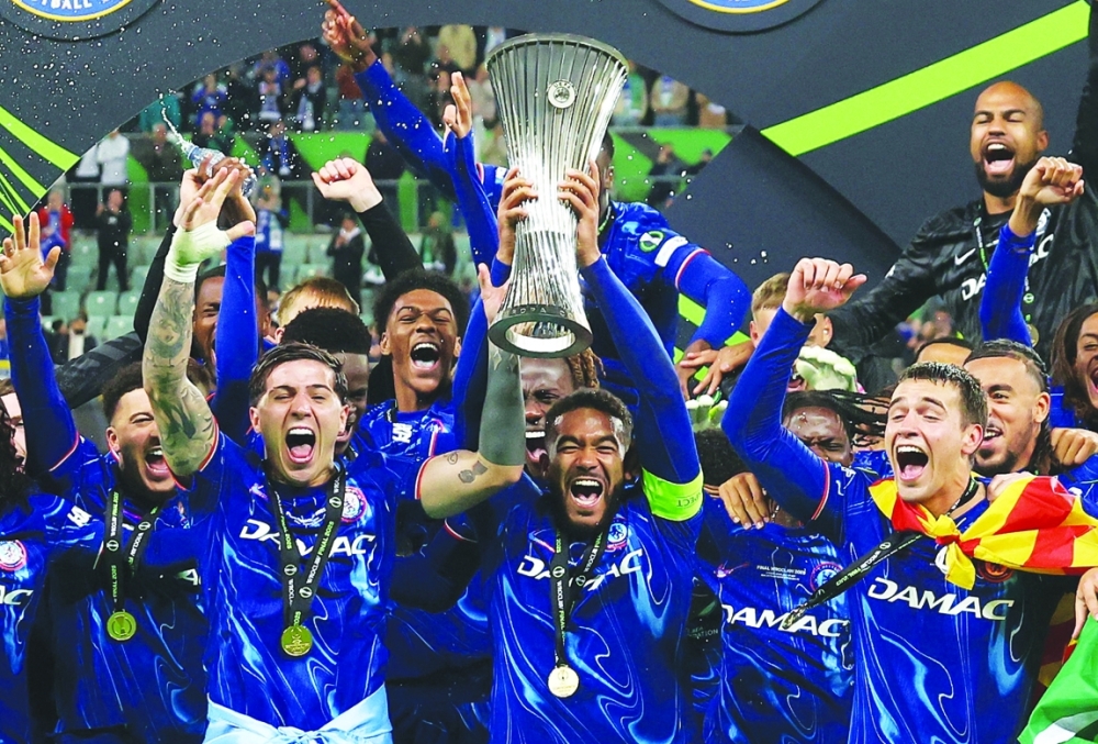 Reece James lifts the trophy with teammates. — Reuters