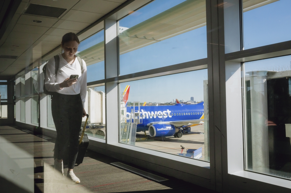A passenger walks through the terminal near Southwest planes at Dallas Love Field in Dallas, Texas, Nov. 15, 2024. (Desiree Rios/The New York Times)