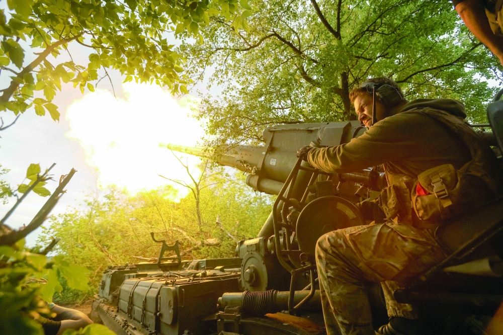 A Ukrainian serviceman fires a gun toward Russian positions, in Donetsk region. — Reuters