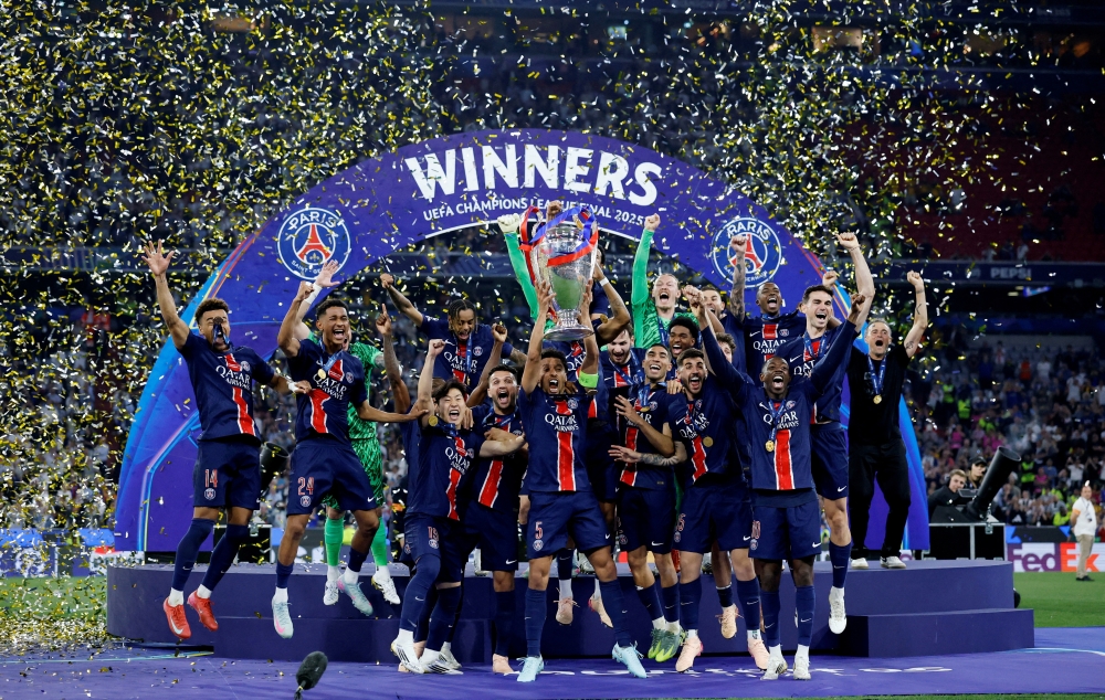 Paris St Germain's Marquinhos lifts the trophy as he celebrates with teammates after winning the Champions League REUTERS/
