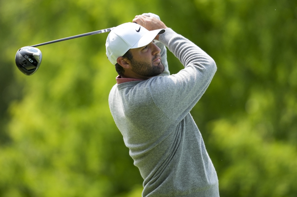 Scottie Scheffler plays his shot from the second tee. — Reuters