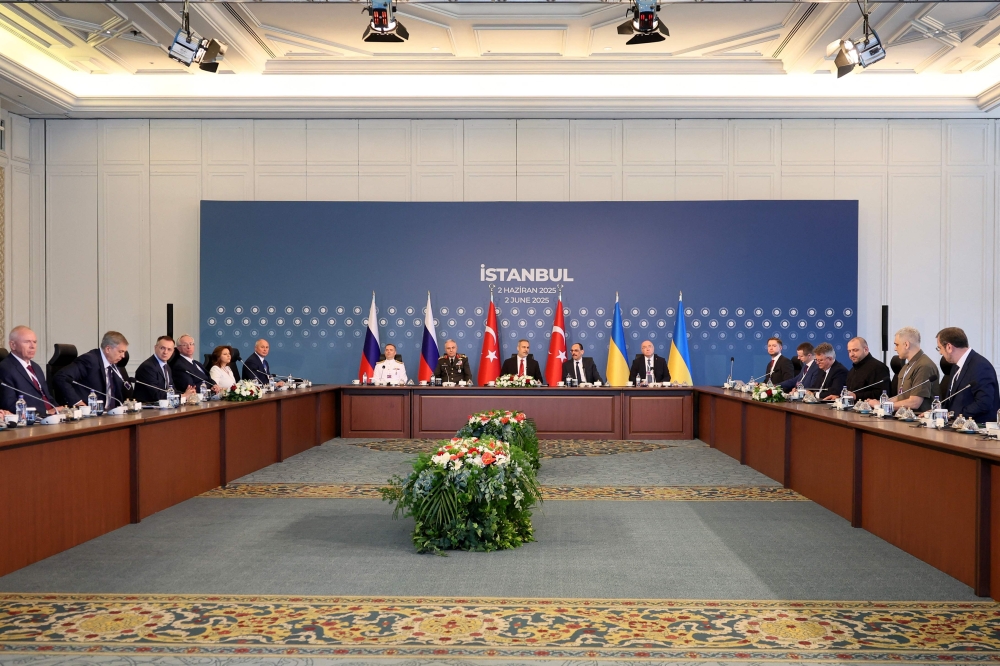 Members of Ukrainian (R), Russian (L) and Turkish (C) delegations attend the second meeting at the Ciragan Palace, in Istanbul. — AFP