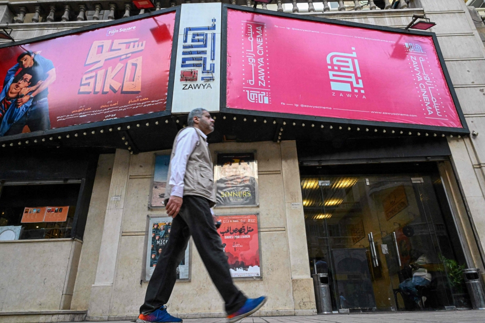 A man walks outside the Zawya cinema in downtown Cairo on May 1, 2025. In the heart of Cairo, a small cinema has for over a decade offered a unique space for independent film in a country whose industry is largely dominated by commercial considerations (Photo by Khaled DESOUKI / AFP)

