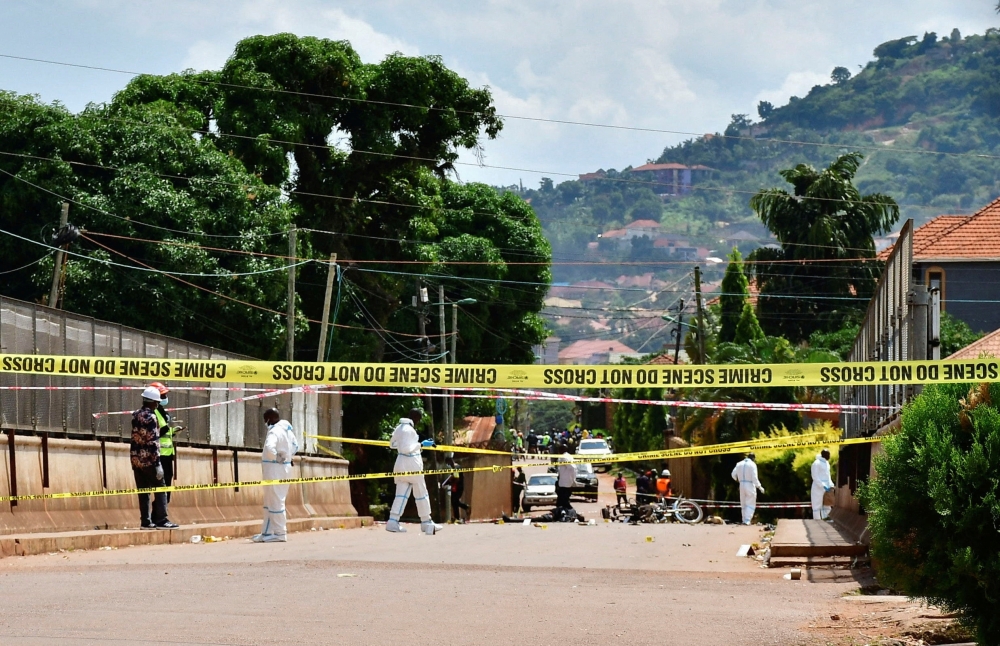 SENSITIVE MATERIAL. THIS IMAGE MAY OFFEND OR DISTURB    Forensic experts secure the scene of a bomb blast near the Munyonyo Martyrs' Shrine, a Roman Catholic shrine as Ugandans assembled to celebrate Martyrs' Day, which commemorates Christians who were killed for their faith in the 19th century, in Munyonyo suburb of Kampala, Uganda June 3, 2025. REUTERS/Abubaker Lubowa
