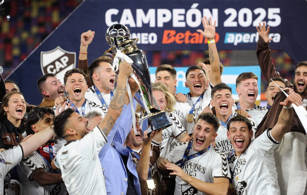 Platense players celebrate with the trophy. — AFP
