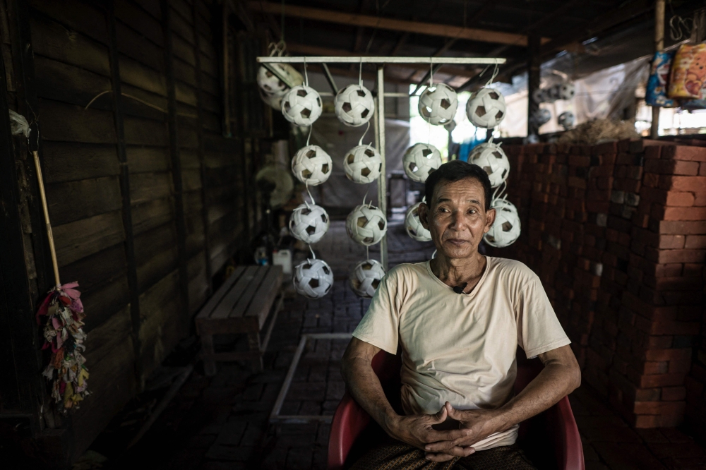 This photo taken on May 8, 2025 shows Mg Kaw, owner of a production workshop for chinlone balls, used in the ancient Myanmar game considered a blend between sport and art, in Hinthada township in the Irrawaddy delta region. Mastering control of the rising and falling rattan chinlone ball teaches patience, says a veteran of the traditional Myanmar sport -- a quality dearly needed in the long-suffering nation.
 - To go with 'MYANMAR-SPORT-CULTURE-CONFLICT-CHINLONE,FOCUS' by Lynn MYAT and Hla-Hla HTAY
 (Photo by Sai Aung MAIN / AFP) / To go with 'MYANMAR-SPORT-CULTURE-CONFLICT-CHINLONE,FOCUS' by Lynn MYAT and Hla-Hla HTAY

