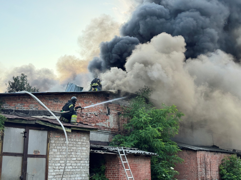 Firefighters work at the site of the Russian drone strike, in Kharkiv. — Reuters